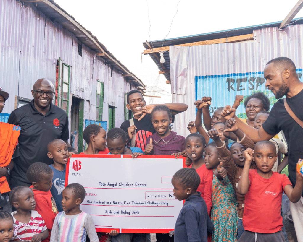 An image showing Humphrey Muchuma talking to people at toto children's home