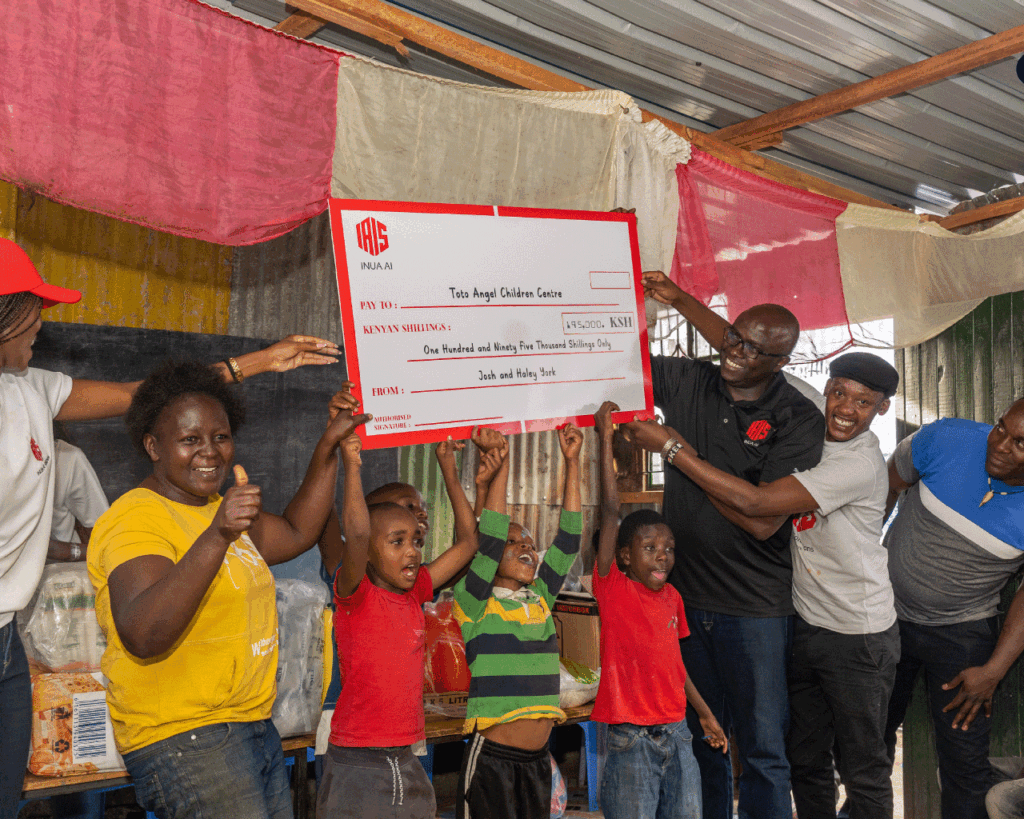 An image showing Humphrey Muchuma talking to people at toto children's home