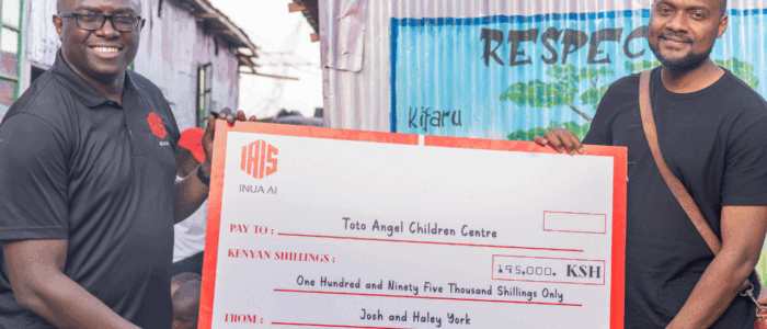 An image showing Humphrey Muchuma talking to people at toto children's home