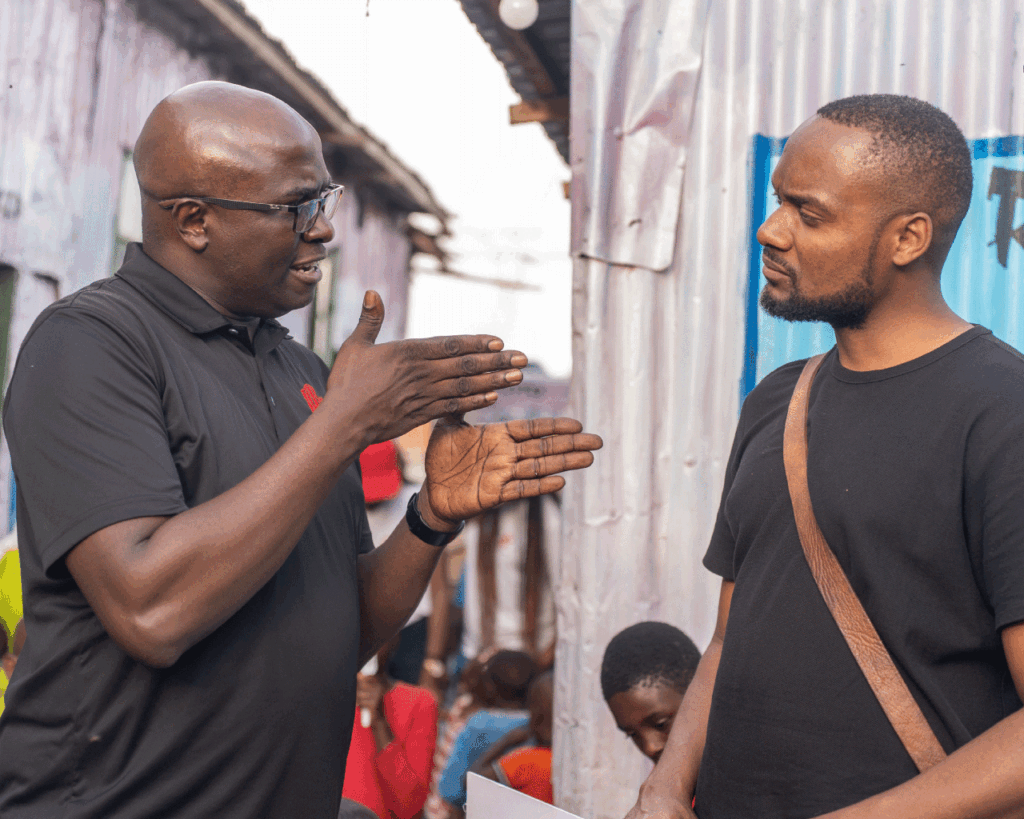 An image showing Humphrey Muchuma talking to people at toto children's home
